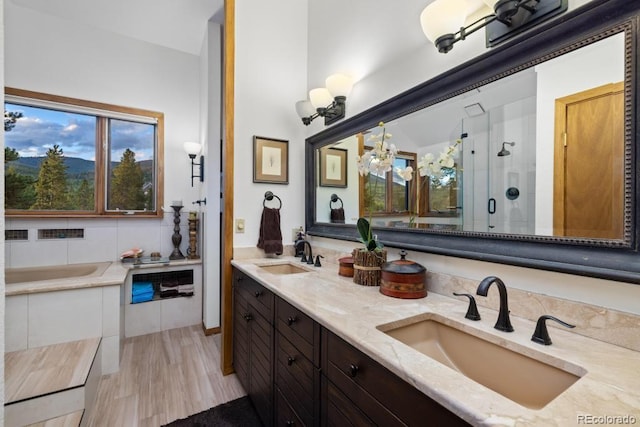 82 Lenawee Ln, Dillon, CO 80435 - full bathroom with a shower stall, a bath, double vanity, and wood finished floors