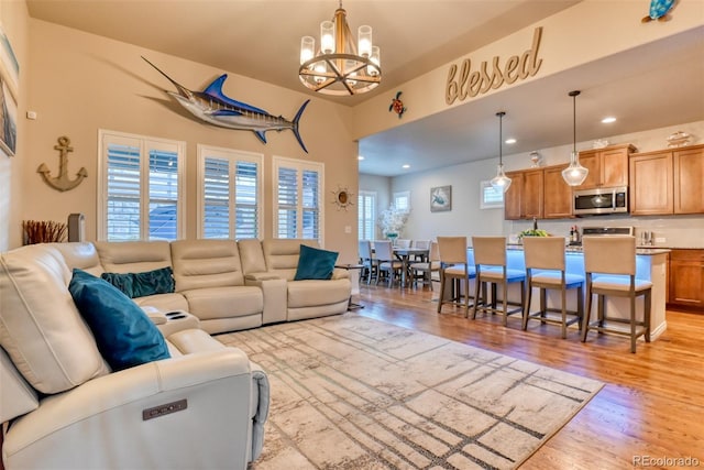 4544 Portillo Pl, Colorado Springs, CO 80924 - living area with a notable chandelier, light wood-style floors, and recessed lighting