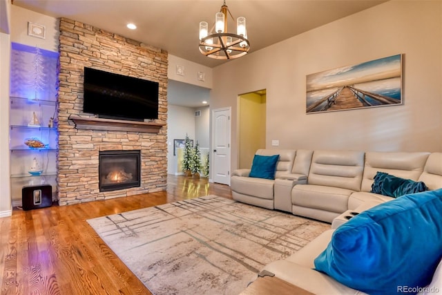 4544 Portillo Pl, Colorado Springs, CO 80924 - living area with a stone fireplace, wood finished floors, and a chandelier