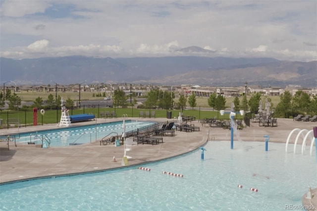 4544 Portillo Pl, Colorado Springs, CO 80924 - pool with fence, a patio area, and a mountain view