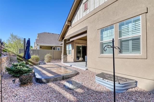4544 Portillo Pl, Colorado Springs, CO 80924 - exterior space with board and batten siding, stucco siding, a patio, and fence