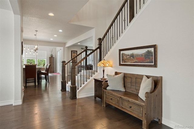 interior space featuring dark hardwood / wood-style flooring and a chandelier