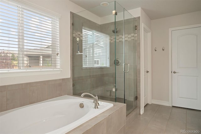 bathroom featuring a healthy amount of sunlight, tile patterned floors, and independent shower and bath