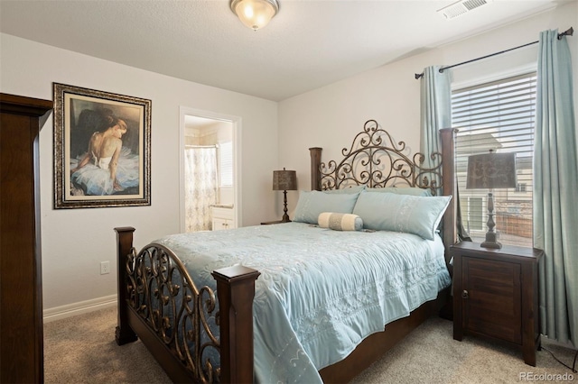 bedroom featuring multiple windows, carpet, and connected bathroom