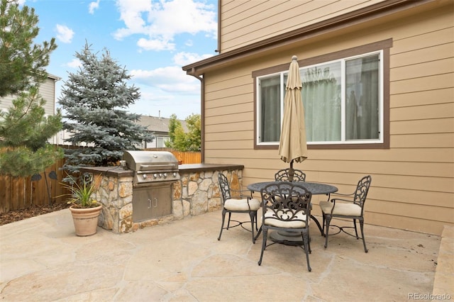 view of patio with area for grilling and an outdoor kitchen