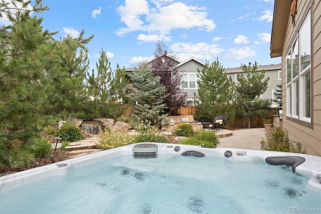 view of swimming pool with a patio and a hot tub