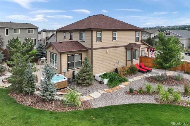 rear view of house featuring a lawn