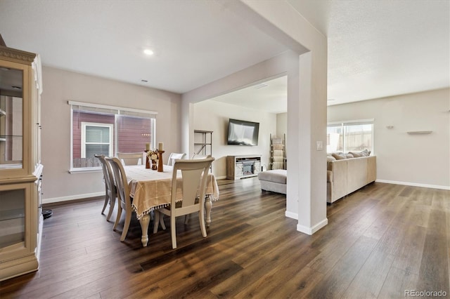 dining space with dark wood-style floors and baseboards