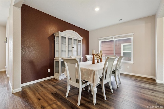 dining room featuring baseboards and dark wood finished floors