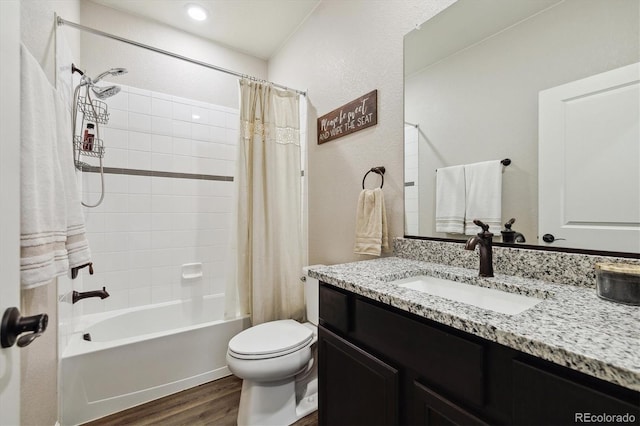 bathroom with toilet, vanity, wood finished floors, and shower / bath combo with shower curtain