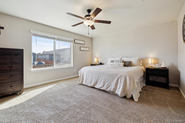 bedroom with ceiling fan, carpet, and baseboards