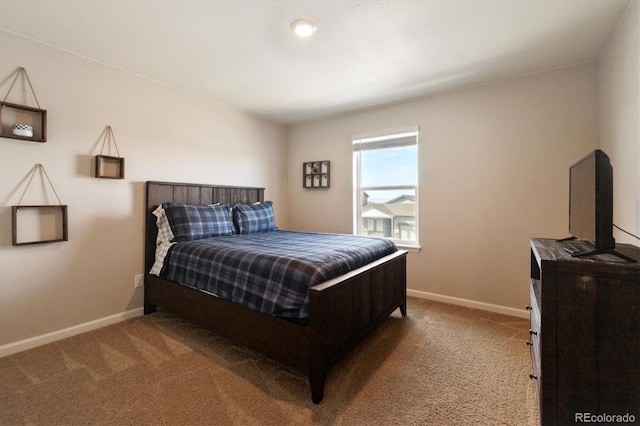 carpeted bedroom featuring baseboards