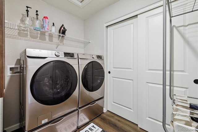 washroom with dark wood-style floors, laundry area, and washer and clothes dryer