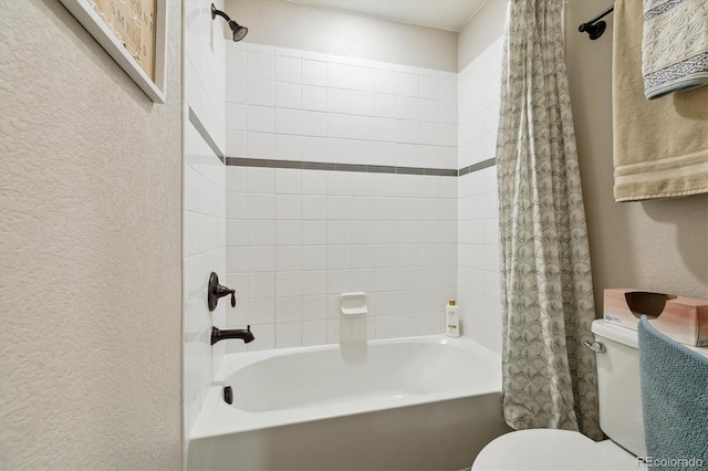 full bathroom with a textured wall, toilet, and shower / bath combo with shower curtain