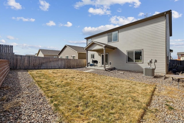 back of property featuring a patio area, a fenced backyard, a lawn, and central AC unit