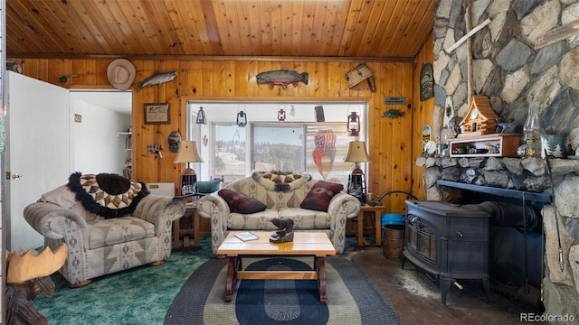 living room with wooden ceiling, a wood stove, and wooden walls