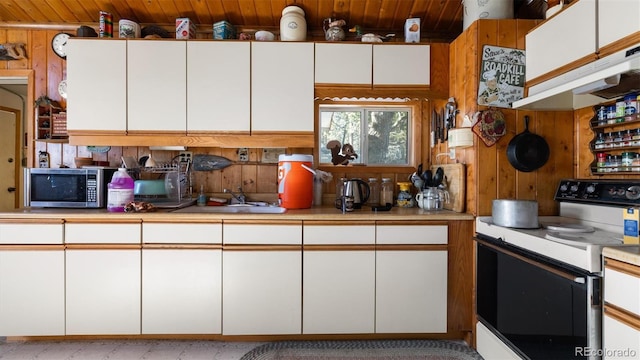 kitchen with white electric range oven, white cabinetry, wood ceiling, and sink