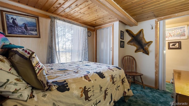 carpeted bedroom with beam ceiling, wood ceiling, and a closet