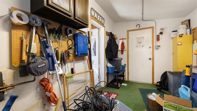 interior space featuring dark colored carpet and a workshop area