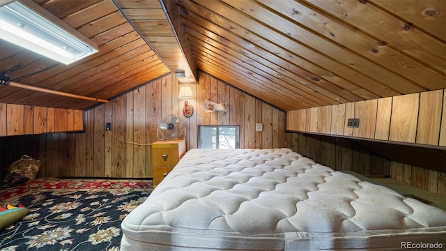 bedroom featuring wood walls, vaulted ceiling, and multiple windows