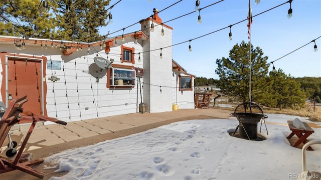 view of home's exterior featuring an outdoor fire pit