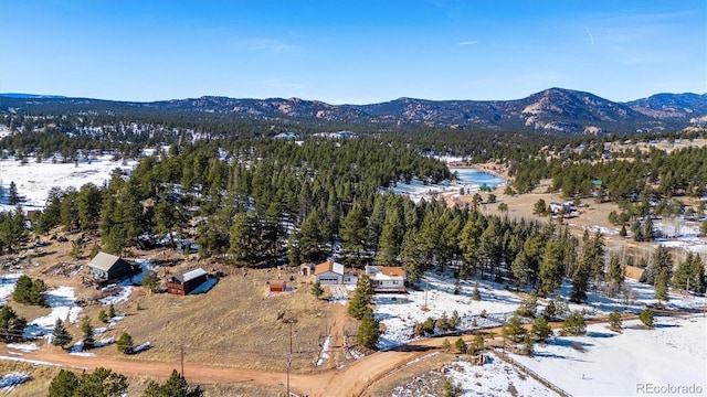 snowy aerial view featuring a mountain view