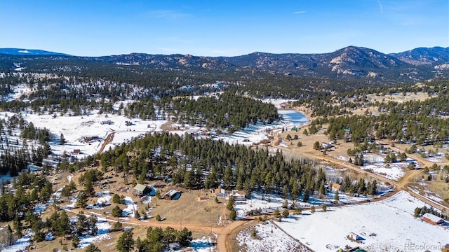 snowy aerial view with a mountain view