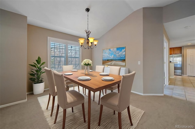 dining area featuring an inviting chandelier, vaulted ceiling, and light colored carpet