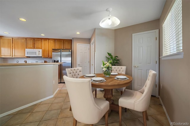 dining space featuring light tile patterned floors