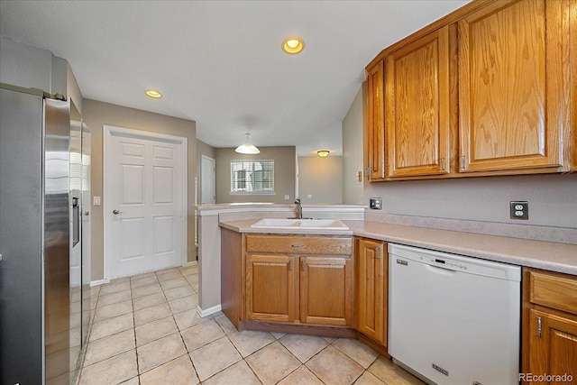 kitchen featuring dishwasher, sink, light tile patterned floors, kitchen peninsula, and stainless steel refrigerator with ice dispenser