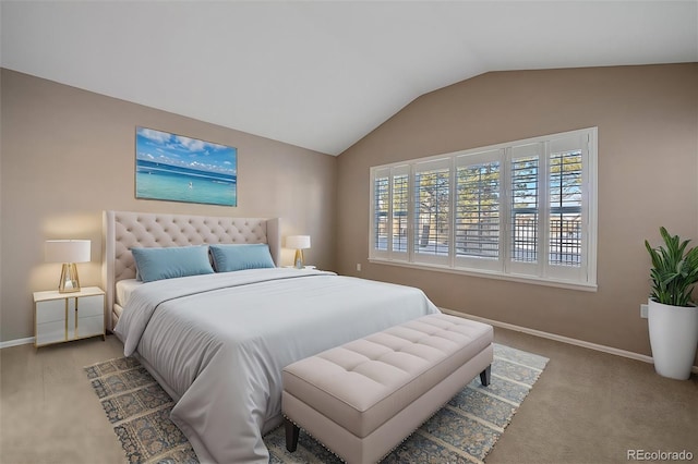 carpeted bedroom with lofted ceiling