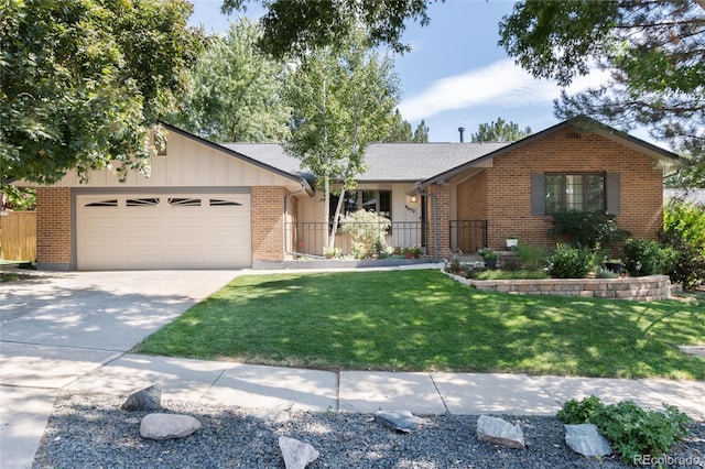 single story home with a garage and a front lawn