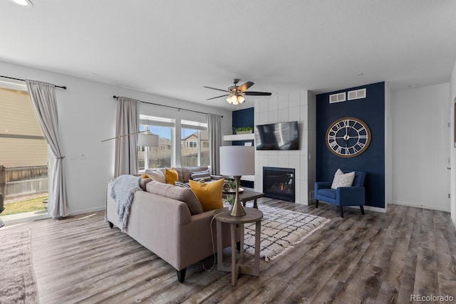 17960 Weymouth Ave, Parker, CO 80134 - living room featuring wood finished floors, a ceiling fan, and a tile fireplace