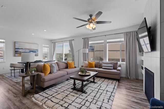 17960 Weymouth Ave, Parker, CO 80134 - living area with wood finished floors, ceiling fan, a fireplace, and recessed lighting