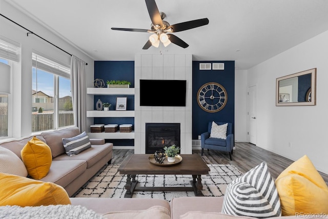 17960 Weymouth Ave, Parker, CO 80134 - living area with wood finished floors, a ceiling fan, and a fireplace