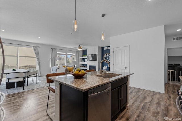 17960 Weymouth Ave, Parker, CO 80134 - kitchen with stainless steel dishwasher, wood finished floors, a ceiling fan, decorative light fixtures, and recessed lighting