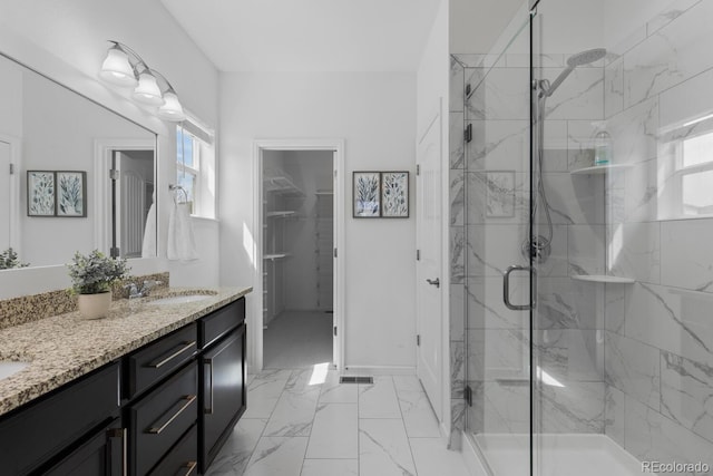 17960 Weymouth Ave, Parker, CO 80134 - full bath featuring a marble finish shower, double vanity, a spacious closet, and marble look tile flooring