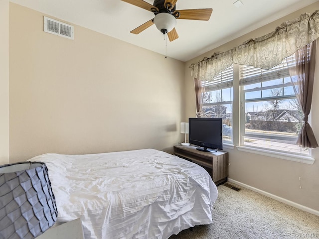 carpeted bedroom with baseboards, visible vents, and ceiling fan