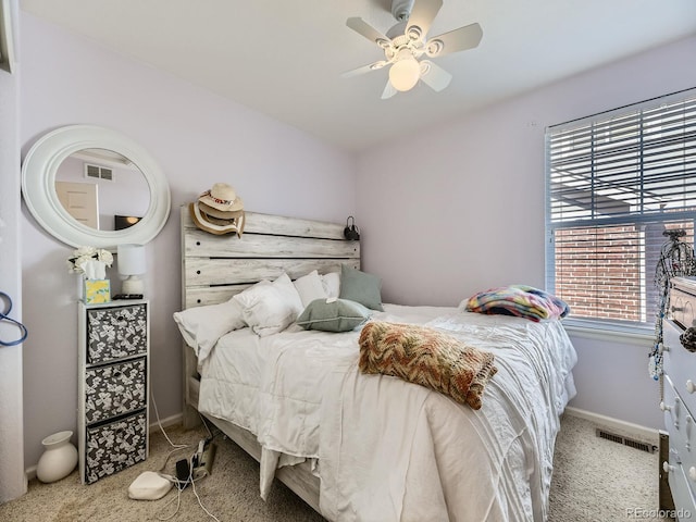 carpeted bedroom featuring a ceiling fan, baseboards, and visible vents