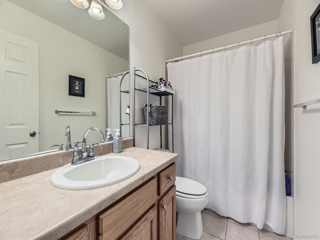 full bathroom featuring toilet, vanity, and tile patterned flooring