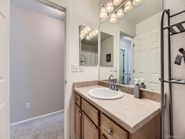 full bathroom featuring baseboards and vanity