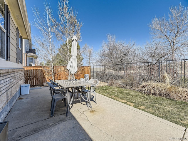 view of patio with outdoor dining space and a fenced backyard