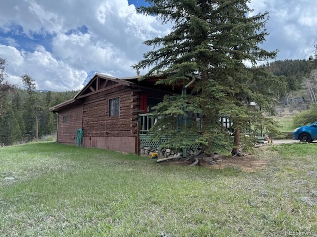 view of side of home featuring a yard