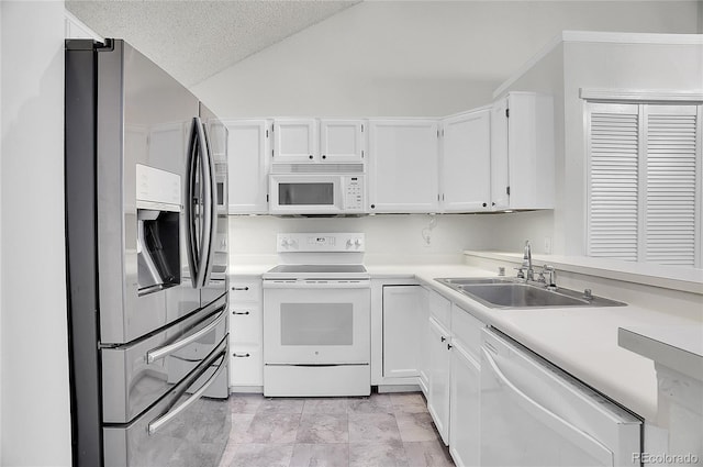 kitchen with a textured ceiling, white appliances, white cabinetry, and sink