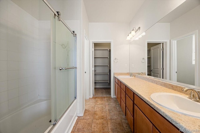 bathroom with vanity and shower / bath combination with glass door