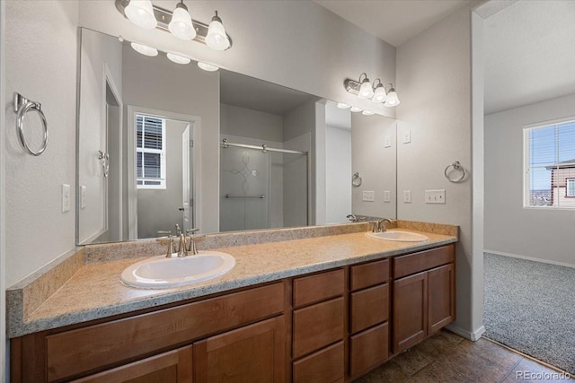 bathroom featuring vanity, a shower with shower door, and tile patterned flooring