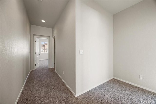 hallway featuring dark carpet