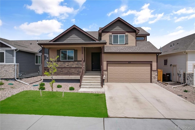 827 Forest Canyon Rd, Severance, CO 80550 - view of front of home featuring a porch, an attached garage, driveway, a front yard, and stone siding
