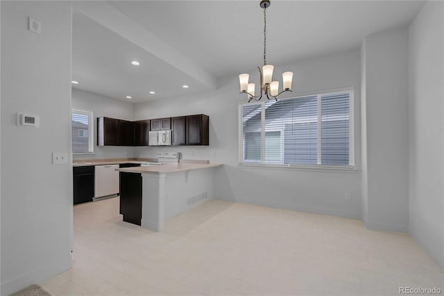 827 Forest Canyon Rd, Severance, CO 80550 - kitchen with white appliances, recessed lighting, light countertops, a chandelier, and a peninsula