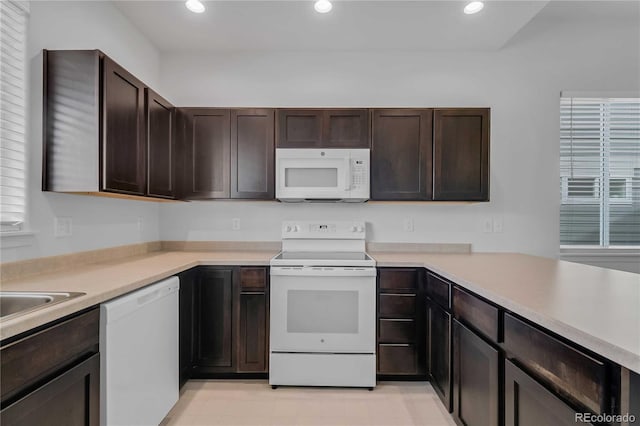 827 Forest Canyon Rd, Severance, CO 80550 - kitchen featuring white appliances, dark brown cabinetry, recessed lighting, light countertops, and a sink